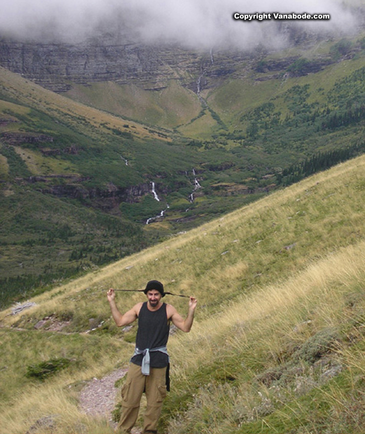 picture of jason and waterfalls in the back ground in glacier