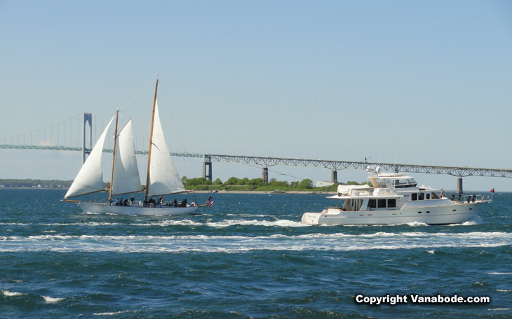 ships sail and motor past in  Newport Harbor