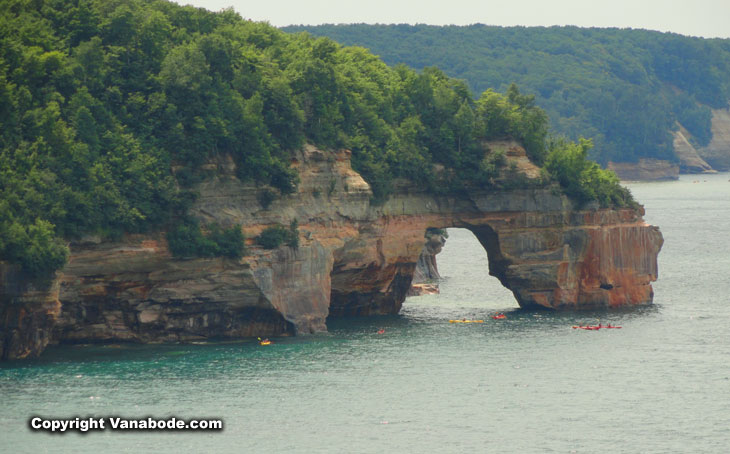 kayaks float among the cliffs offshore