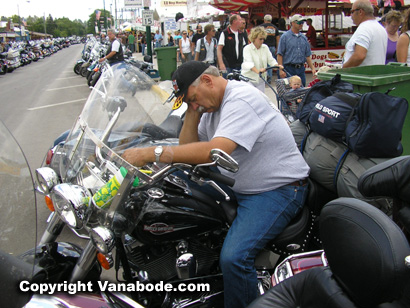 guy sleeping on motorcycle at sturgis motorcycle rally