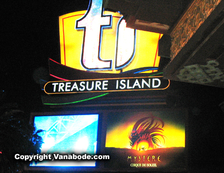 Photograph shows Treasure Island Hotel in Las Vegas kiosk on the Strip at night with an ad for Mystere, the Cirque du Soleil show headlining here.